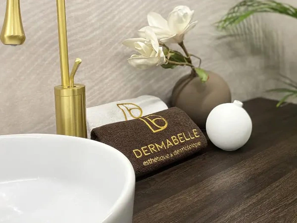 DERMABELLE embroidered towels next to the salon sink