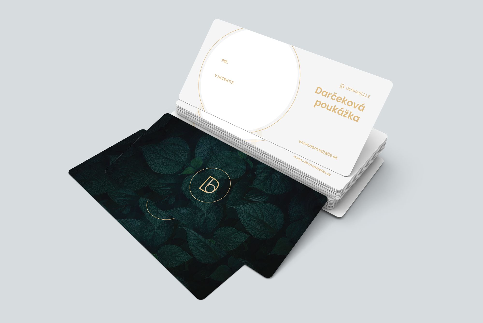 DERMABELLE gift cards stacked on a grey background