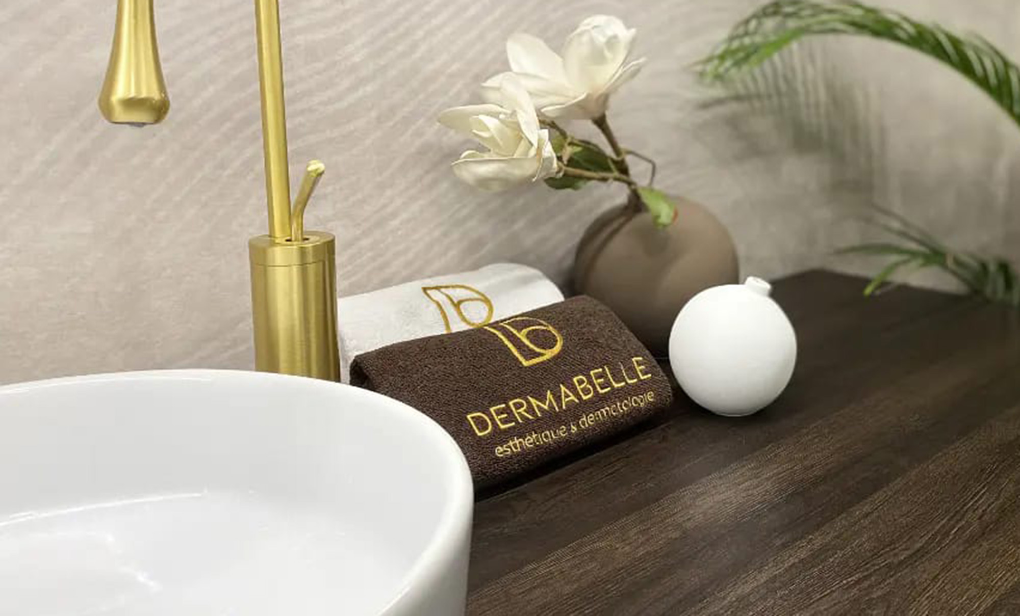 DERMABELLE embroidered towels next to the salon sink